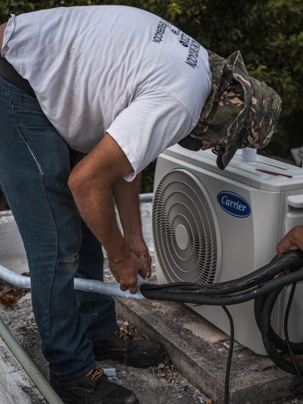 HVAC technician installing air conditioning unit
